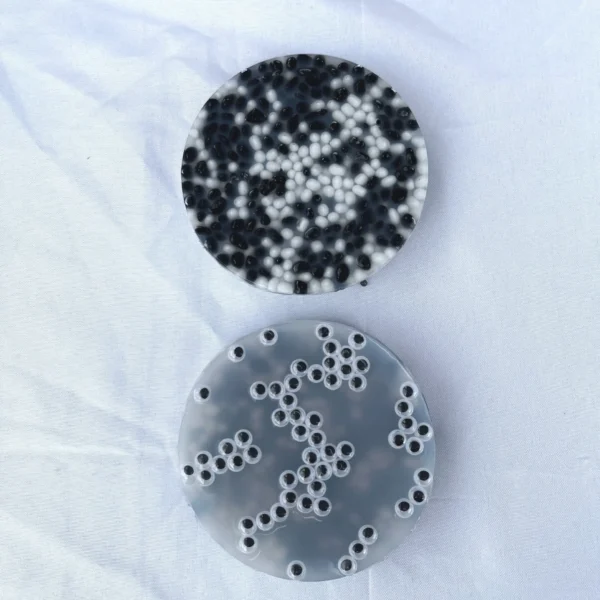 Two picky pads, each containing black and white pebbles