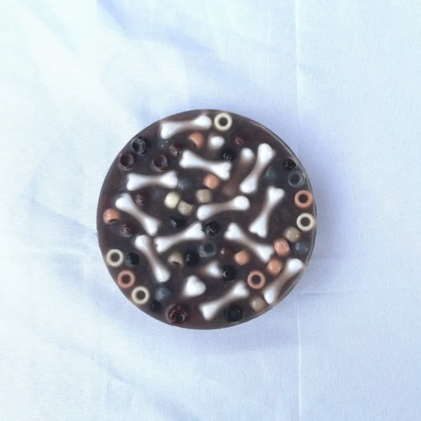 A picky pad made with brown pony beads and miniature dog bones
