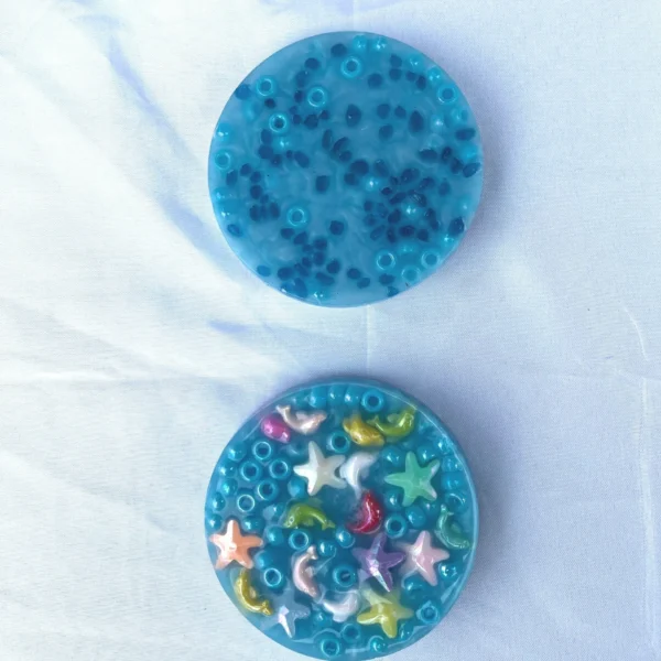 Two picky pads made with aqua pony beads and mini sea creatures
