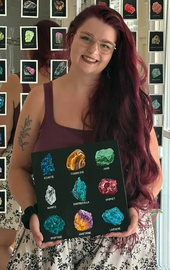 Elise Jackman holding her original Harmony Stones painting